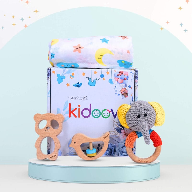 Hello World Baby Gift Set 1 front view with elephant crochet rattle, wooden teethers, and swaddle