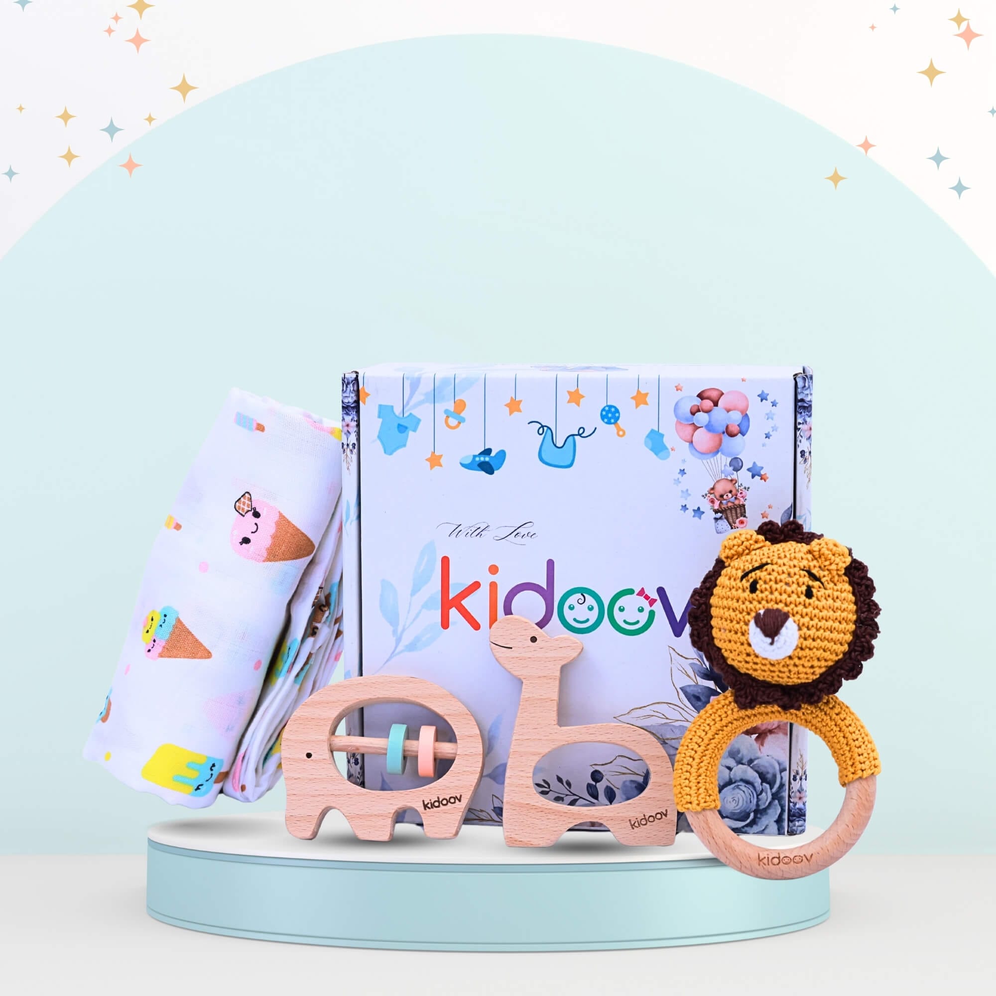 Hello World Baby Gift Set 2 side view with bear crochet rattle, giraffe and elephant wooden teethers, and swaddle